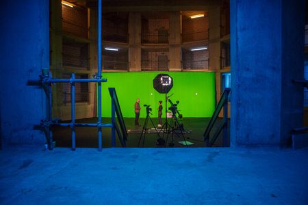 Nick Payne and Diva Amon conversing in front of the studio greenscreen. (National Geographic/Aubrey Fagon)