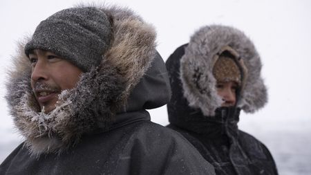 Thomas Ala Apassingok and Nalu Apassingok in the winter, hunting seals. (National Geographic/Zach Clanton)