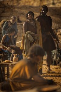 Aurelia Masuri, played by Angelina Chudi, and Marcus Masurius, played by Theo Ogundipe, spot Avianius, played by Frankie Treadaway, across the Pompeii displacement camp. (National Geographic/Darrin Zammit Lupi)