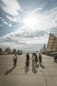 Director Lana Salah, sound recordist Phil Bax, and DOP Jon Southgate-Sayers film student LTJG Evan Morris and his instructor as they return from a flight. (National Geographic/Freddie Claire)
