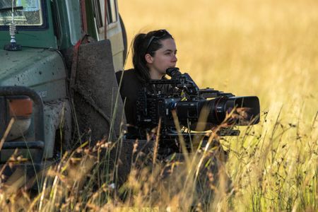 Cinematographer Tania Escobar looks out into the distance at Summer's pride, ready to begin filming as soon as the action starts to unfold. (National Geographic/Joe Treddenick)