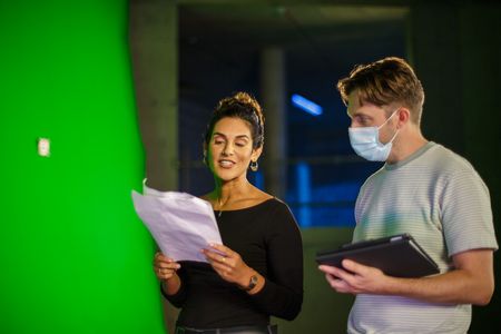 Diva Amon running through lines with director Martin Cass at the studio lab shoot. (National Geographic/Aubrey Fagon)