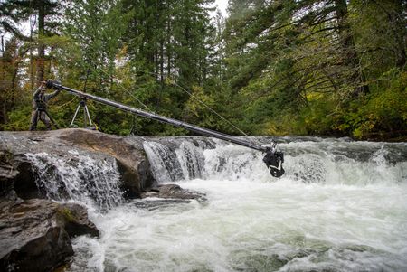 First Camera Operator Derek Frankowski uses a jib to film salmon at a waterfall. (National Geographic for Disney/Ambrose Weingart)