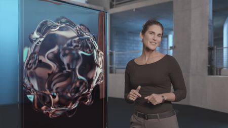 Dr. Diva Amon smiling at the camera while standing next to the GFX 'Coral' special information board whilst in the shark lab studio. (National Geographic)