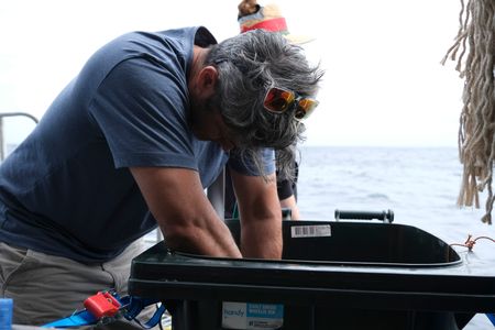 Ryan Johnson preparing the 'buring whale carcass' replica for the leaching experiment. (National Geographic/Mariana Kneppers)