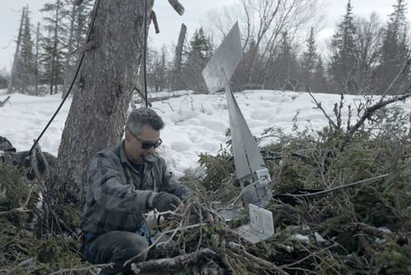 Joel Jacko installs a windmill on his property for additional power. (National Geographic/Wayne Shockey)