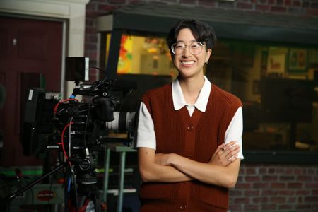 A-Bel Gong standing with arms crossed next to video equipment. (National Geographic/Robert Toth)