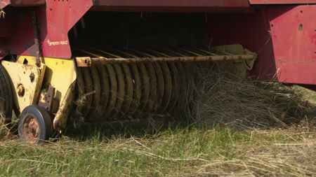 The hay baler baling the dried out hay from the hayfield at the Pol family's farm. (National Geographic)