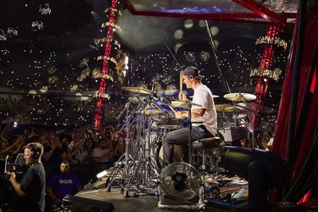 Chris Hemsworth drums during the Ed Sheeran concert in Bucharest. (credit: National Geographic/Evan Paterakis)