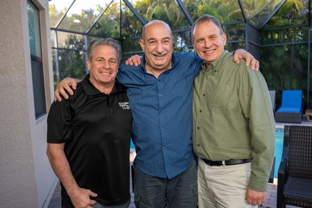 Scott Fox, John McLoughlin, and John Busching pose together during their reunion. McLoughlin was trapped in the rubble of the World Trade Center for 22 hours after 9/11, and Busching and Fox were two of the people who helped rescue him.  (National Geographic/Harrison Cooney)