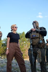 Mariana van Zeller stands with El Gato, co-founder of the Black Cat Rifle Group. (National Geographic)