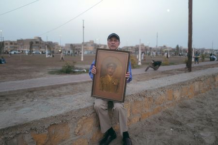 Shahid Khan, Akbar Khan's great grandson holds a portrait of his great grandfather in Karachi, Pakistan. Major Akbar Khan was the most senior Indian in the British Army during WW2 and a member of Force K6, a little known Indian regiment of mule handlers. Amidst the chaos of Dunkirk and the advancing German Army, the Indian regiment fought for victory and independence. (National Geographic/Daniel Dewsbury)