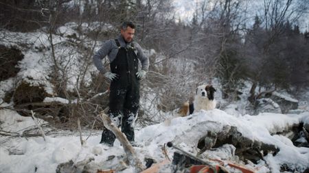 Joel Jacko uncovers his tools after they've been frozen under the snow and ice. (National Geographic)