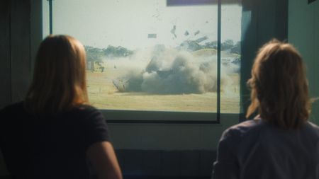 Mariana van Zeller and Nadine Rynners watch as the cash-in-transit truck explode in a controlled setting in Johannesburg, South Africa. (National Geographic)