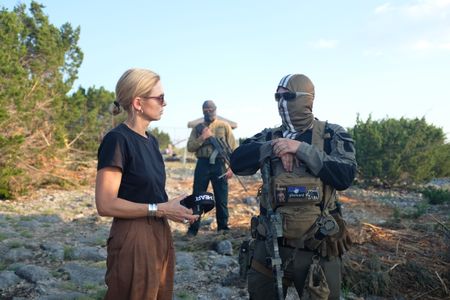 Mariana van Zeller stands with El Gato, co-founder of the Black Cat Rifle Group. (National Geographic)