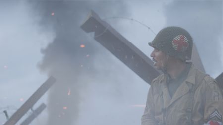 Combat medic Waverly Woodson Jr., (played by Francesco Di Rauso) reacts in a scene of a WW2 historic reenactment production for "Erased: WW2's Heroes of Color." Waverly Woodson Jr. was a combat medic who served with the 320th Barrage Balloon Battalion on D-Day. (National Geographic)
