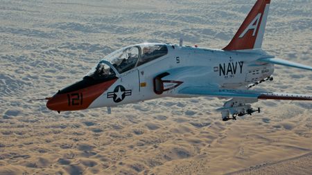 A jet carrying bombs flies to the target during a training exercise. (Credit: National Geographic)