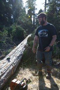 With the help of a neighbor, Oliver Johnson collects lumber. (National Geographic/Kelly Robertson)