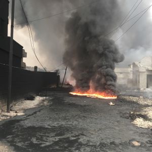 QAYARRAH, IRAQ - Black smoke rises up from the oil fires set by ISIS in Qayarrah village after their departure. (photo credit: Junger Quested Films LLC/Nick Quested)