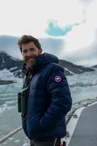 Aldo Kane smiling at the bow of OceanXplorer. (National Geographic/Mario Tadinac)