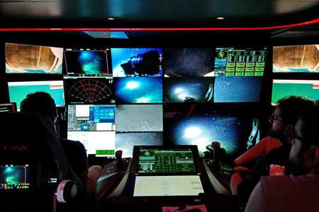 Eric Stackpole and Ewan Basin sit in ROV Mission Control. (National Geographic/Mario Tadinac)
