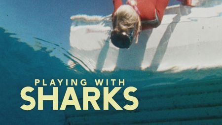 Valerie Taylor leaning over the boat looking into water in 1968. Shot from underwater. (photo credit: Ron & Valerie Taylor)