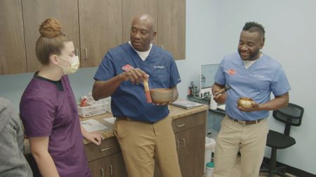 The Docs explain the Tibetan singing bowls to vet tech Logan. (National Geographic for Disney)