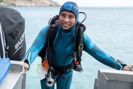 Octopus scientist Dr. Alex Schnell prepares for a dive on the Great Barrier Reef.  (National Geographic for Disney/Craig Parry)