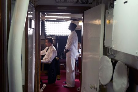 Captain Bennion and mess attendant Doris Miller (played by Crispian Belfrage and Abdul Sulaiman, respectively) are pictured in a WW2 historic reenactment scene for "Erased: WW2's Heroes of Color. The series tells the stories of three Black heroes who miraculously survived the attack on Pearl Harbor. One of these men, mess attendant Doris Miller, defied racial stereotypes when he shot down enemy planes during the attack. (National Geographic/Seye Isikalu)