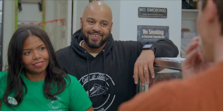 Cuts and Slices founders Ashlee and Randy smile at Antoni. (National Geographic)