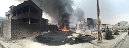QAYARRAH, IRAQ - After leaving Qayarrah, ISIS sets oil fires as a parting gift for the villagers. (photo credit: Junger Quested Films LLC/Nick Quested)