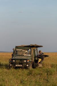 Director of Photography Sophie Darlington sits in the film vehicle, setting up her camera and preparing to film. (National Geographic/Claire Arthur)
