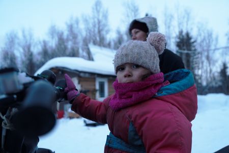 Chevelle Roach sits in a snowmobile, ready to set rabbit snares with her family. (BBC Studios Reality Productions, LLC/Jayce Kolinski)