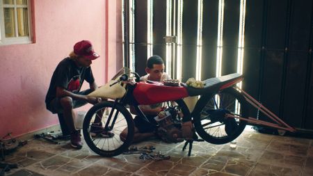 Tico and Manolo get their bike ready for the big race. (National Geographic)