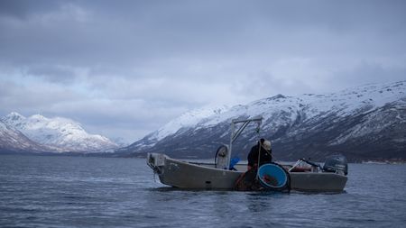 Marvin Agnot sets crab pots in the water. (National Geographic/Ashton Hurlburt)