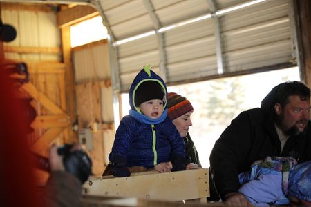 Silas Pol, Beth Pol, Charles Pol, and Abigail Pol check on the Merino sheep's newly born babies at the Pol family's farm. (National Geographic)