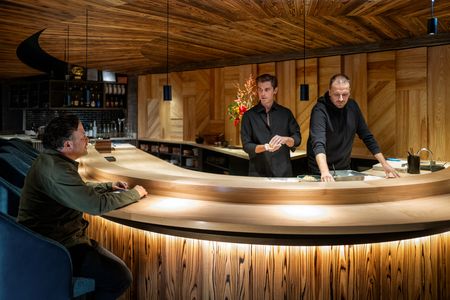 Antoni Porowski prepares dumplings at Ikigai with chef Rafal and owner Dan. (National Geographic/Jill Worsley)