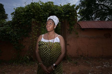 Delisha Marshall stands in the courtyard where her ancestor, Peter 'Gumpa' Lee, might have lived, had he not been exiled by King Glele over 160 years ago. (National Geographic/Etinosa Yvonne)