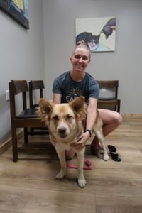 Kim Borchert holds her dog, Diamond, as they wait to be seen at the clinic. (National Geographic)