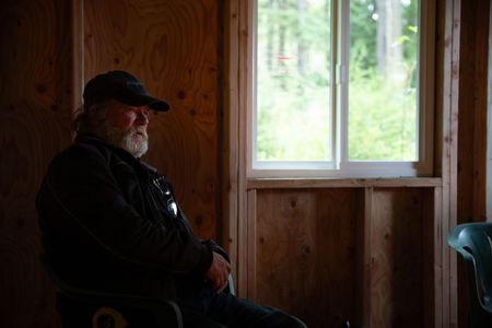 Terry Simpson is grateful for his neighbors' help in building him a new cabin. (National Geographic/Robert Jolley)