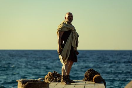 The Praetorian, played by Barry Aird, stands on the jetty at Herculaneum with his back to the sea. (National Geographic/Darrin Zammit Lupi)