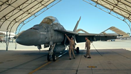 Student LTJG Andrew Seepe gets up close to his dream jet, an F-18. (Credit: National Geographic)