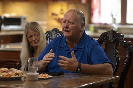 Bill Spade and his wife during their reunion with Carol D'Allara. (National Geographic/Virginia Sherwood)