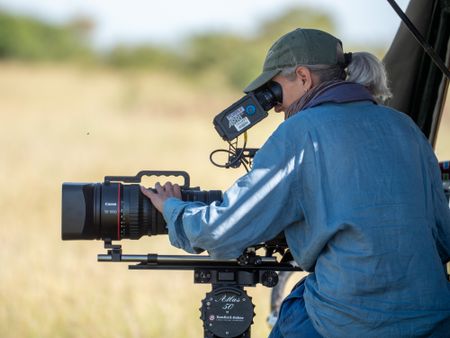 Director of Photography Sophie Darlington looks through the camera as she films the unfolding drama within Summer's Pride. (National Geographic/Faith Musembi)