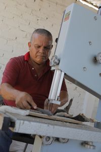 The "Finman" cuts a shark fin. (National Geographic)