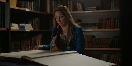 Kathleen Martinez looking through a book in the Greco-Roman Museum. (credit:  National Geographic)