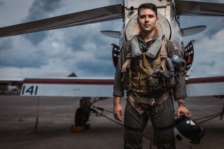 Student LTJG Marcus Figueroa poses behind a T-45. (Credit: National Geographic/Freddie Claire)