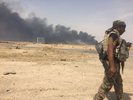 QAYARRAH, IRAQ - After leaving Qayarrah, ISIS sets oil fires as a parting gift for the villagers. (photo credit: Junger Quested Films LLC/Nick Quested)