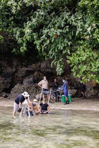 Secrets of the Octopus crew, Rory McGuinness, Woody Spark, Yvonne Press, Jaap Barendrecht, and Siladen Resort team members work together to film the landscape around Bunaken Marine Park.   (photo credit: National Geographic/Harriet Spark)