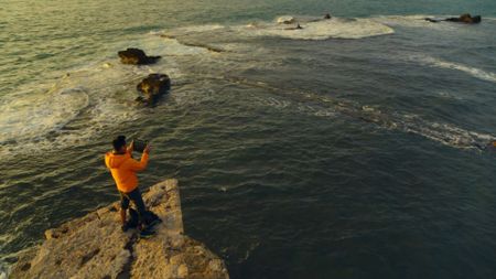 Acre, Israel - Albert Lin with iPad overlooking lagoon. (National Geographic)